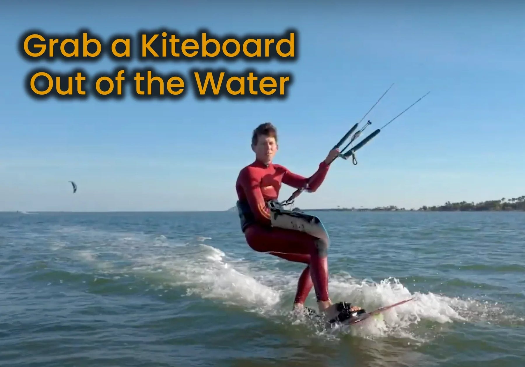 How do I grab a kiteboard out of the water while riding?