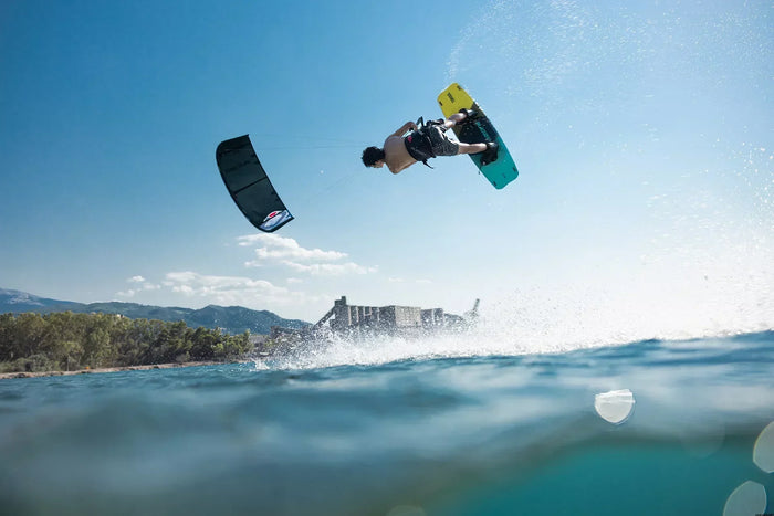 Rider popping a controlled freestyle jump on the Ozone AMP V2 in steady wind conditions